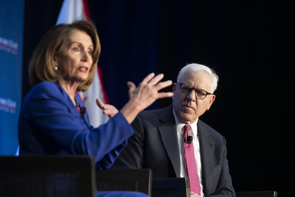 David Rubenstein, co-founder of The Carlyle Group, on stage with Nancy Pelosi. (Alex Edelman/Bloomberg)